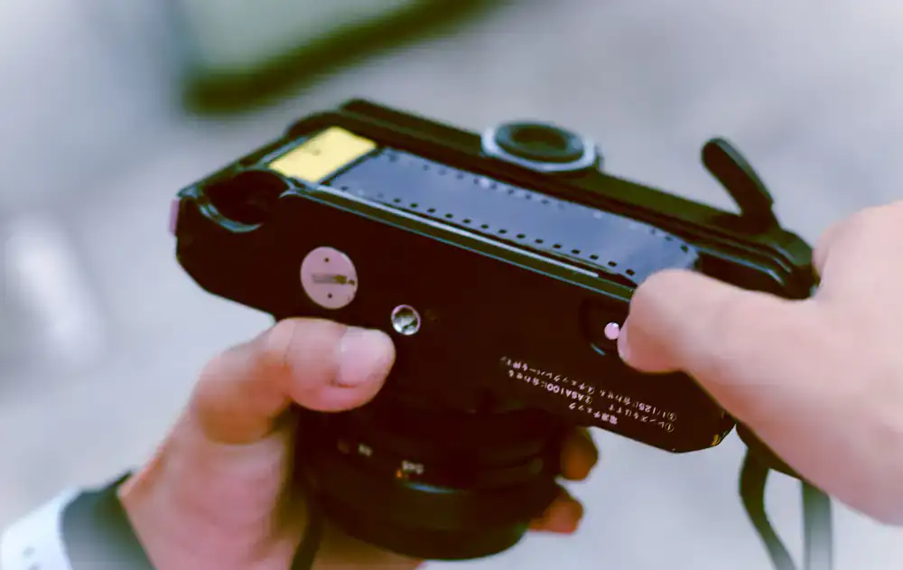 Vintage film camera being adjusted