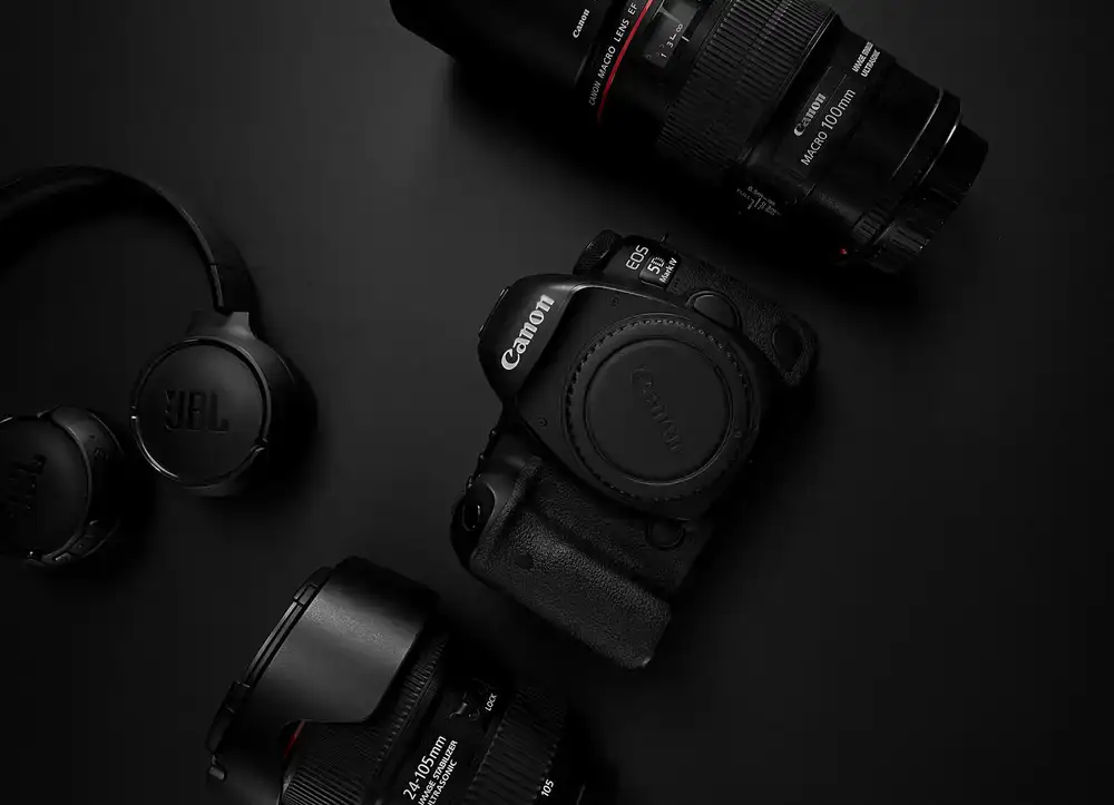 A clean, well-lit counter showing camera lenses and bodies ready for testing.